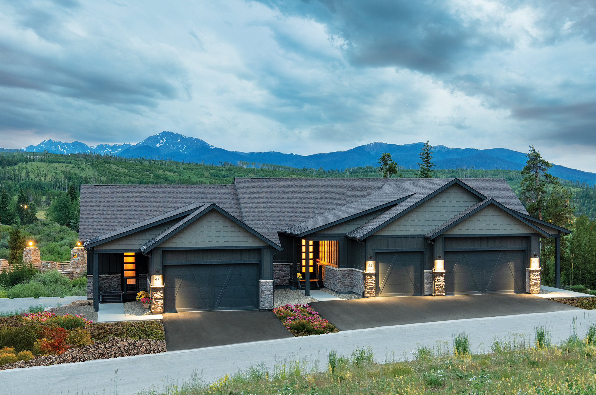 Modern house at dusk with mountainous backdrop
