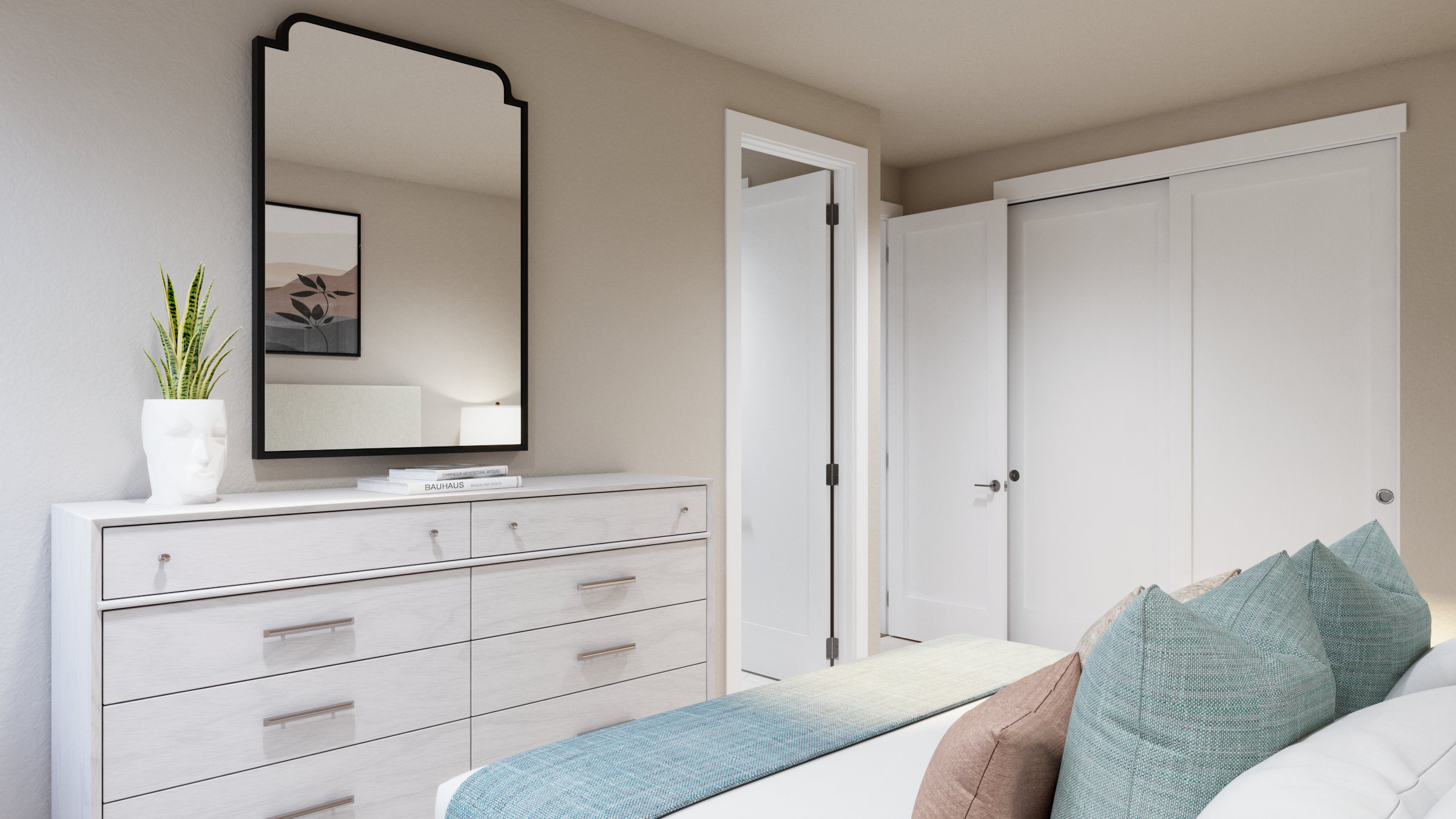 A bedroom with dresser, mirror, plant, and pillows