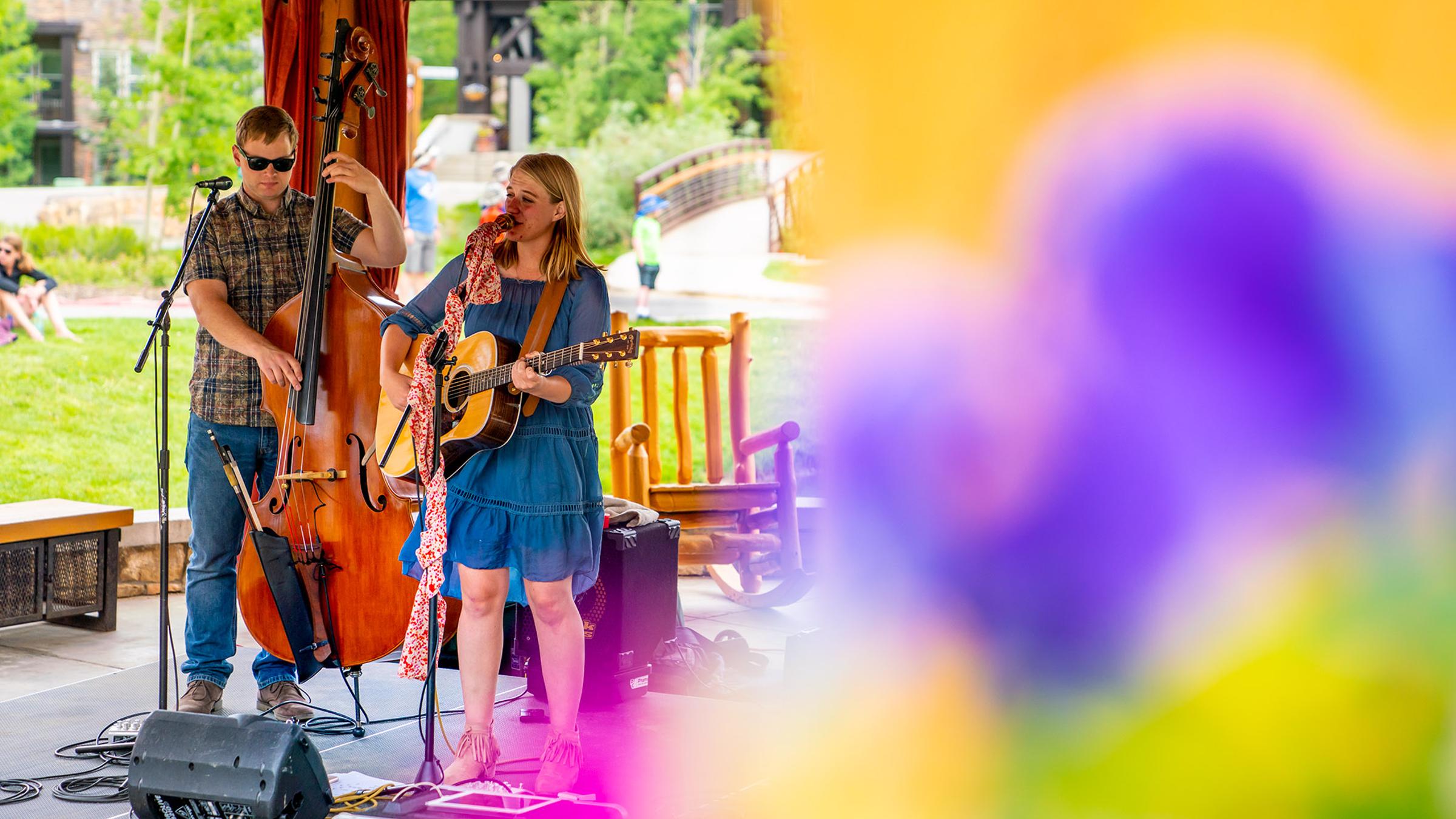 Outdoor performance with a musician and a bassist.