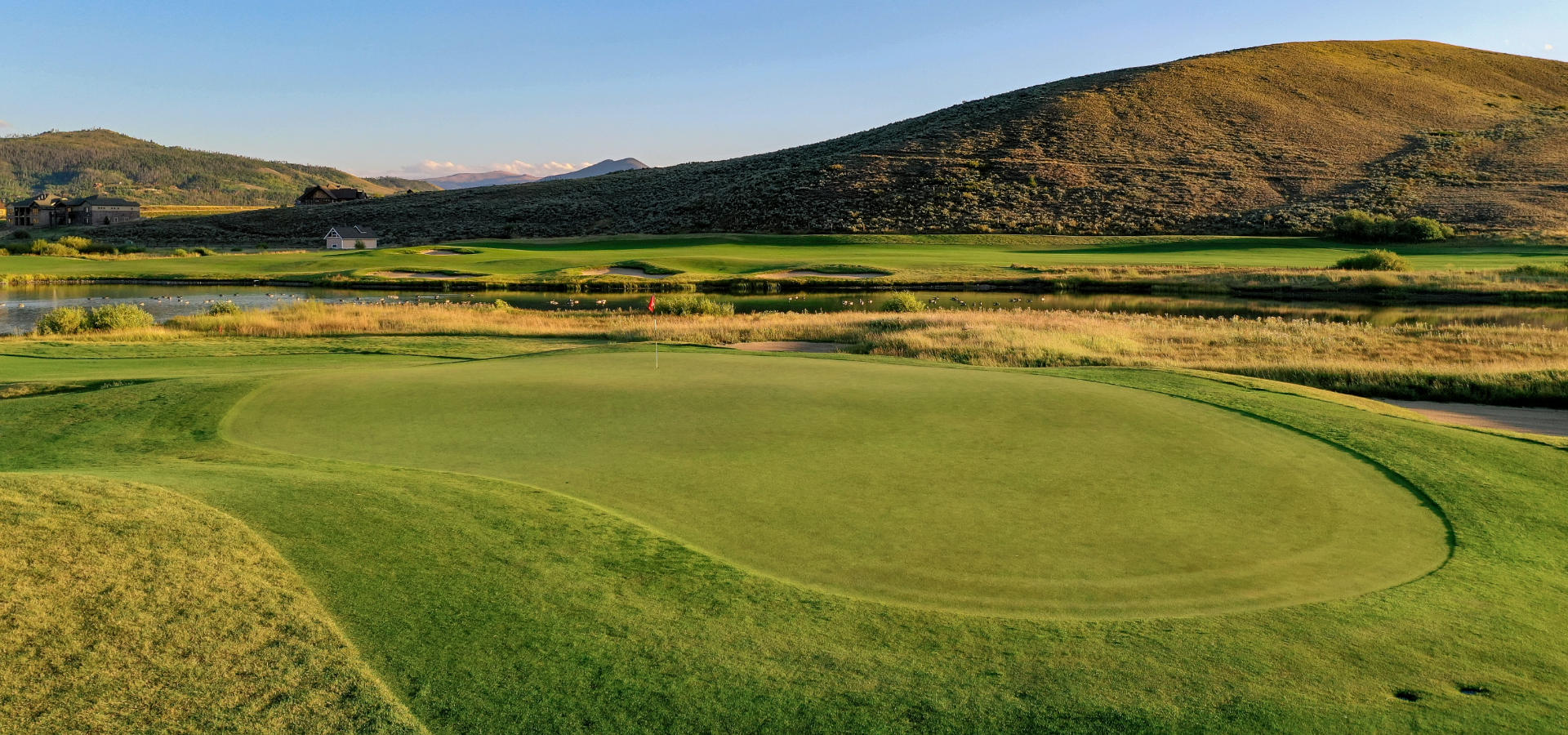 Golf course with mountains in the background